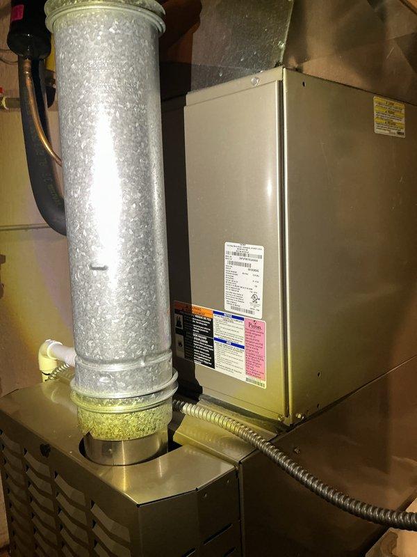 # HVAC Maintenance Service Completed

Performed scheduled air conditioning maintenance on residential HVAC system. Upon inspection, discovered severely frosted evaporator coils indicating restricted airflow or potential refrigerant issues. The frost accumulation was extensive across all serpentine coil tubes and header manifold, requiring immediate attention. Noted corrosion present in drain pan beneath coils, suggesting ongoing moisture management concerns.

Replaced air filter and evaporator pad as part of routine maintenance protocol. Inspected air handler unit and associated ductwork connections. All manufacturer labels and safety warnings verified as intact and legible. Condensate drain system checked for proper operation. Documented system condition through photographic evidence for maintenance records.

System requires monitoring for proper defrost cycling and airflow restoration following filter replacement.