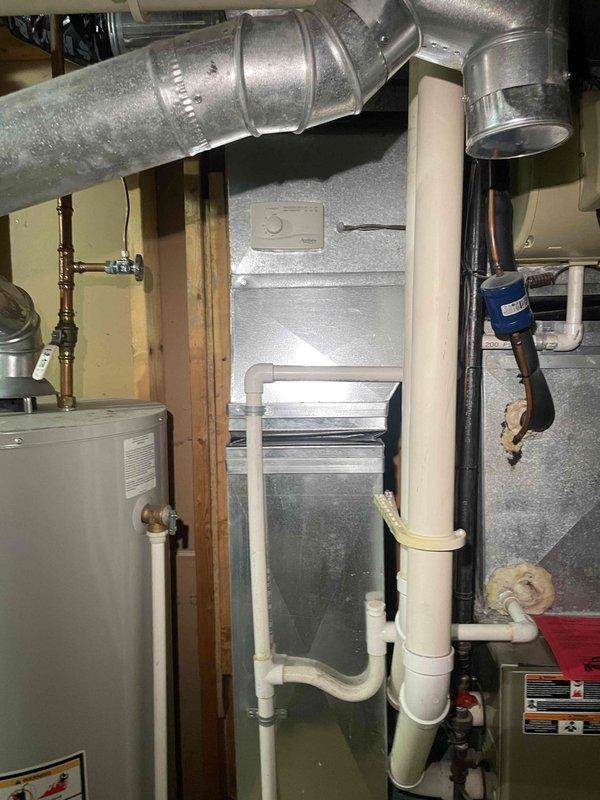 Provided comprehensive estimate for complete HVAC system replacement in basement location due to non-functional furnace with cracked heat exchanger. Assessed existing aged equipment configuration including furnace, air conditioning system, air handler with Air Bear filtration unit, and associated ductwork and drainage systems. Recommended full system replacement to address safety concerns from compromised heat exchanger and improve overall system efficiency and reliability.
