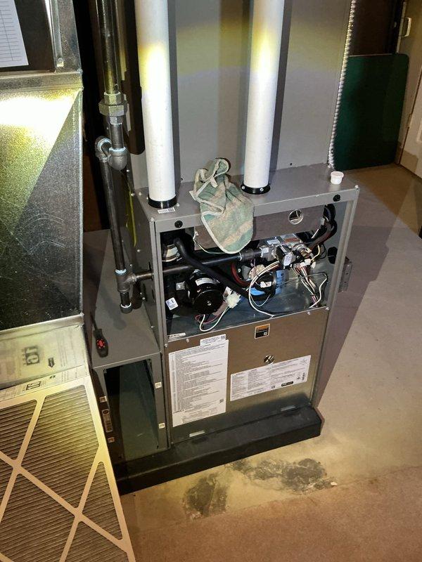 Completed comprehensive ComfortGuard Maintenance visit on residential HVAC system, performing standard inspection and maintenance procedures on furnace and air handler unit. Inspected air filtration system with mesh filter panel housed in metal ductwork frame, verified proper airflow through flexible duct connections, and examined blower motor assembly with associated wiring harnesses. All components found operating within normal parameters with no specialty service requirements identified during this recurring maintenance visit.