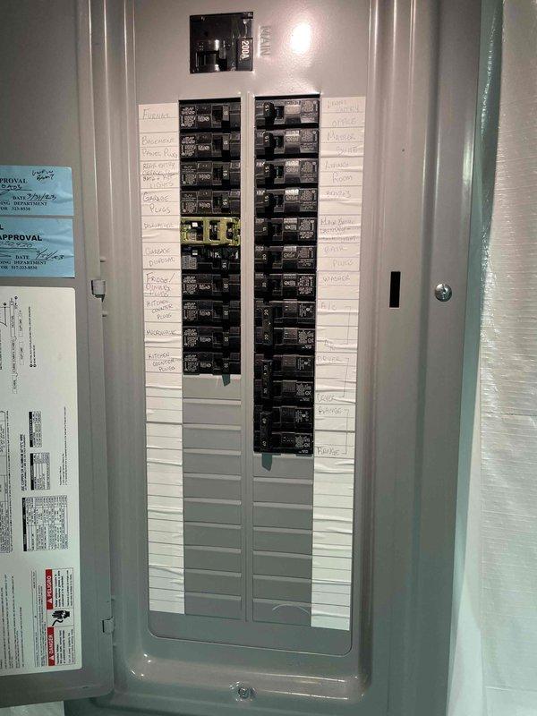 Conducted comprehensive site evaluation for mini split system installation. Assessed existing electrical panel capacity and circuit availability to determine feasibility of adding mini split equipment. Photographed electrical distribution panel showing current circuit configuration and available breaker spaces for future installation planning. Evaluated potential indoor unit mounting location in workspace area with existing ceiling fan. Current central AC system is three years old and operational. Customer considering mini split installation as supplemental or alternative cooling solution with decision timeline of approximately two months. Provided technical assessment and recommendations for system sizing and placement based on room configuration and electrical infrastructure.