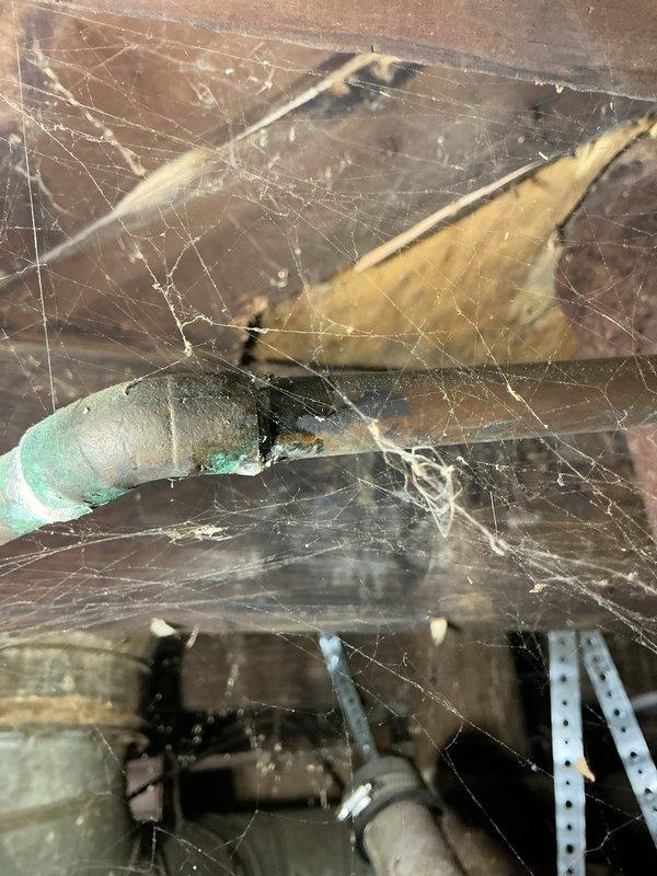 Responded to no-heat call following recent basement flooding. Upon arrival, found furnace located in basement with no standing water present. Performed diagnostic inspection of furnace and surrounding area. Observed significant corrosion on gas supply piping and shutoff valve, along with deteriorated plumbing components in vicinity of equipment. Noted extensive cobwebs and aged infrastructure throughout basement mechanical space, indicating lack of recent maintenance access. Documented conditions with photographs showing corroded metal pipes, oxidized copper lines, and compromised connections that may affect system safety and operation. Equipment age unknown; system requires further evaluation to determine if flood-related moisture or existing deterioration caused failure to start.