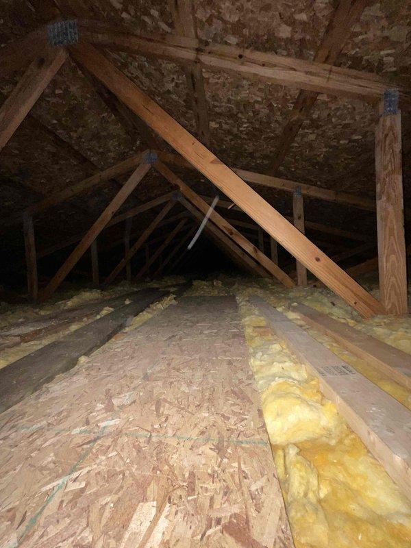 Conducted comprehensive site assessment for new mini split installation to replace existing boiler heating system. Evaluated garage/workshop area with window AC unit and attic space with exposed trusses and fiberglass insulation to determine optimal equipment placement and ductless system configuration. Provided customer with recommendations for converting current heating system to either forced air or mini split solution based on specific room requirements and existing structural conditions.