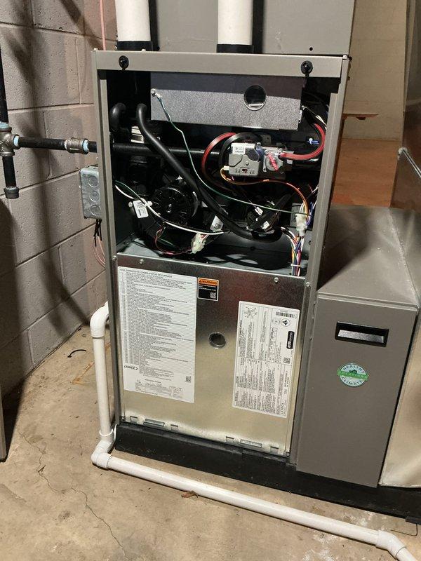Responded to no-heat call on 2017 Monnex four-star furnace system. Upon arrival, found unit completely non-operational with suspected control board communication failure. Performed diagnostic testing on internal components, blower motor assembly, and electrical connections. Inspected thermostat programming and verified proper communication between wall-mounted digital thermostat set to 72°F and furnace control system. Documented furnace interior components and thermostat display for service records.
