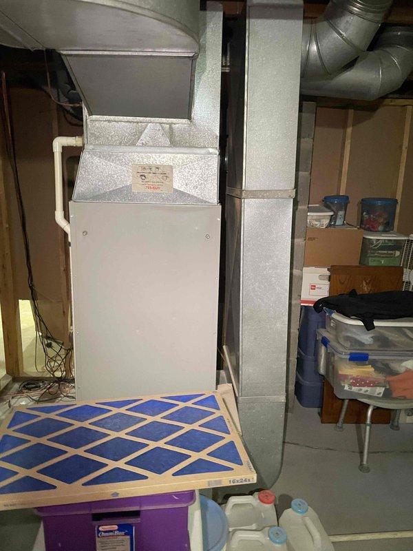 Conducted site assessment for replacement estimate of 30+ year old oil-fired furnace and air conditioning system located in basement. Evaluated existing HVAC equipment configuration including vertical air handler unit, evaporator coil assembly, and ductwork distribution system. Documented current system layout with exposed ductwork routing along ceiling joists and connection points to existing infrastructure. Prepared comprehensive replacement proposals for furnace and air conditioning equipment under promotional program, along with generator installation options featuring both Generac and Kohler models for comparison.