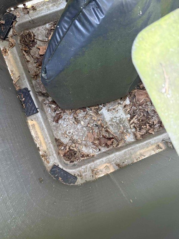 Completed annual cooling maintenance on residential HVAC system. Inspected outdoor condenser unit, which showed heavy pollen accumulation on grille and fan components, along with organic debris collection in drain pan area. Cleaned condenser coils, removed debris from drain pan and condensate line, and verified proper system operation with no deficiencies noted.