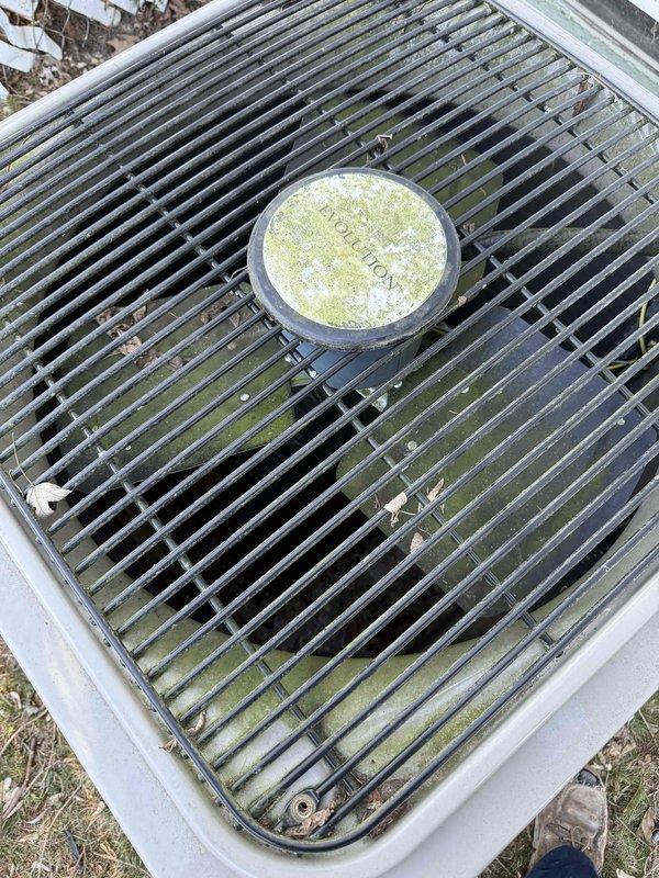 Completed annual cooling maintenance on residential HVAC system. Inspected outdoor condenser unit, which showed heavy pollen accumulation on grille and fan components, along with organic debris collection in drain pan area. Cleaned condenser coils, removed debris from drain pan and condensate line, and verified proper system operation with no deficiencies noted.