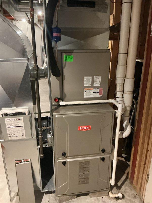 # HVAC Annual Maintenance Completed

Performed comprehensive annual cooling maintenance on residential Bryant HVAC system located in basement mechanical room. Conducted thorough inspection of furnace unit and associated components including water heating equipment, ductwork, and piping systems.

## Work Performed

Inspected Bryant furnace unit and verified all technical specifications and safety labels were legible and intact. Examined PVC condensate drainage system, metal piping, valves, and flexible duct connections for proper operation and secure mounting. Verified water heater controls and connections were functioning correctly.

Discovered severely clogged air filter with heavy accumulation of dust, dirt, and debris significantly restricting airflow through the HVAC system. The metal mesh filter exhibited substantial particulate buildup concentrated in multiple areas, indicating extended service interval without replacement. This condition would have reduced system efficiency and 