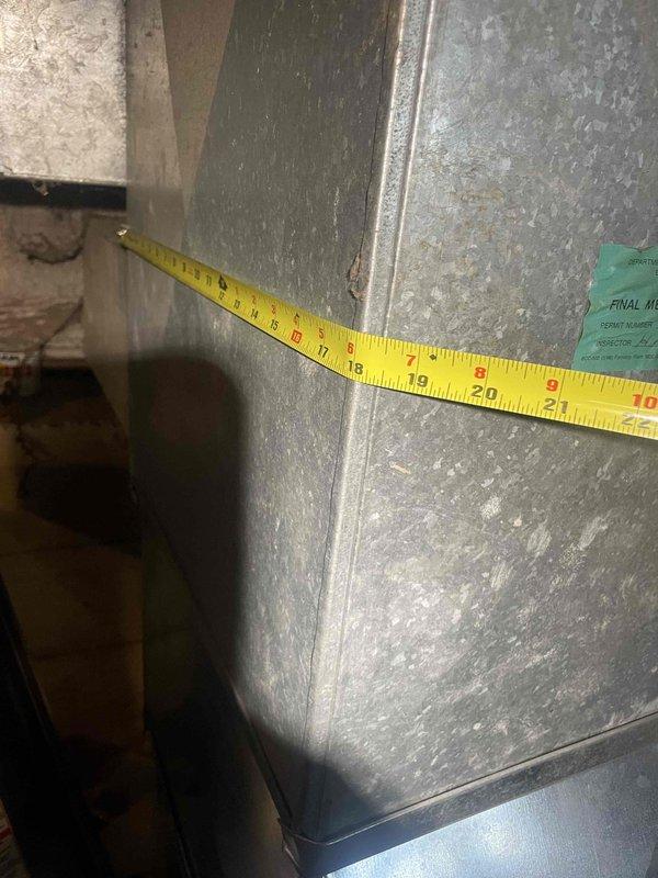 Conducted on-site assessment for replacement estimate of existing furnace and tank-style water heater. Measured supply and return ductwork dimensions to verify compatibility with new equipment specifications, documenting 18-20 inch trunk line and associated plenum connections. Photographed existing HVAC infrastructure including galvanized ductwork configuration, mounting locations, and clearance requirements for accurate equipment sizing and installation planning.