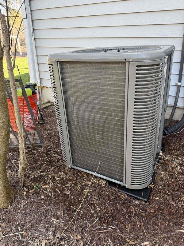 Performed scheduled air conditioning maintenance on outdoor condenser unit. Inspected unit and identified heavily soiled mesh filter panel with significant accumulation of dust, debris, and organic matter requiring replacement. Replaced dirty filter and evaporative cooling pad to restore proper airflow and system efficiency.