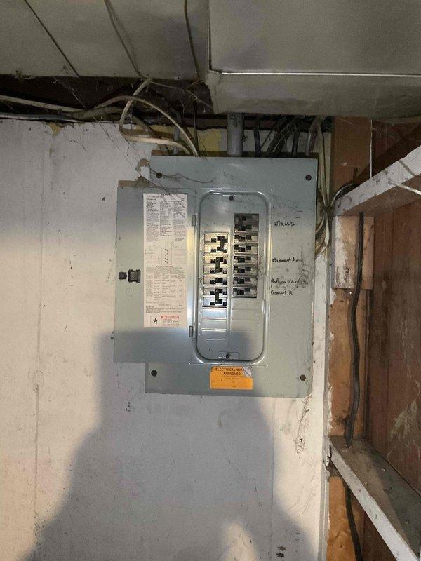 Performed comprehensive furnace inspection following basement flood event on a 4-5 year old forced air heating system that had been shut down as a precaution. Evaluated electrical components, breaker panel connections, and overall system integrity to determine if water damage had affected the unit's safety and functionality. Documented electrical panel condition and surrounding utility area, assessed potential moisture exposure to HVAC equipment, and provided full system estimate for any necessary repairs or replacement components identified during the inspection.