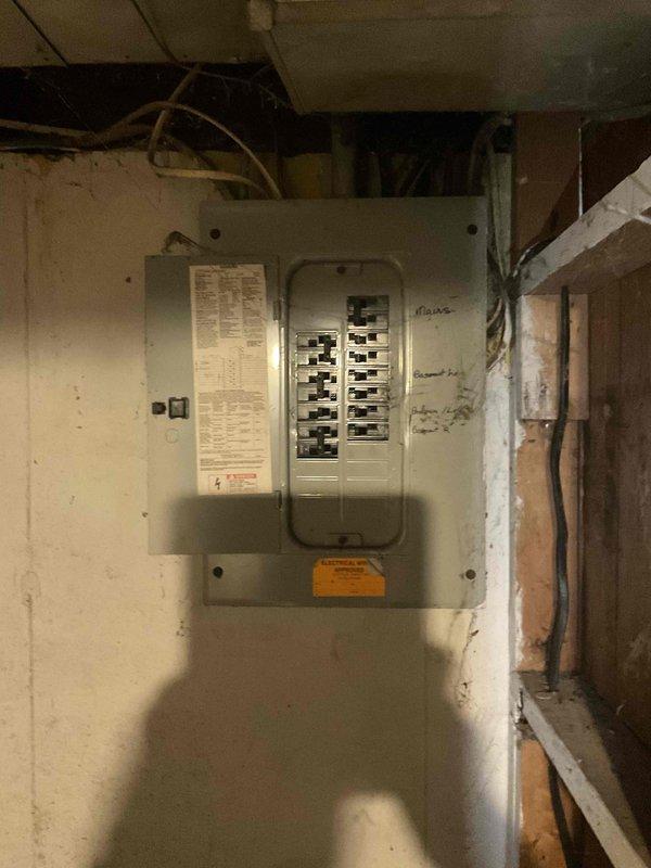 Performed comprehensive furnace inspection following basement flood event on a 4-5 year old forced air heating system that had been shut down as a precaution. Evaluated electrical components, breaker panel connections, and overall system integrity to determine if water damage had affected the unit's safety and functionality. Documented electrical panel condition and surrounding utility area, assessed potential moisture exposure to HVAC equipment, and provided full system estimate for any necessary repairs or replacement components identified during the inspection.