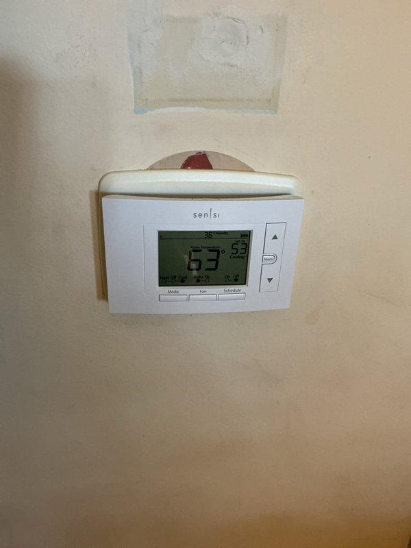 Installed new Sensi smart thermostat to replace existing unit, including proper wiring configuration and system testing. Performed air conditioning maintenance inspection of evaporator coil and ductwork, confirming proper operation and temperature settings at 73°F with humidity reading of 55%.