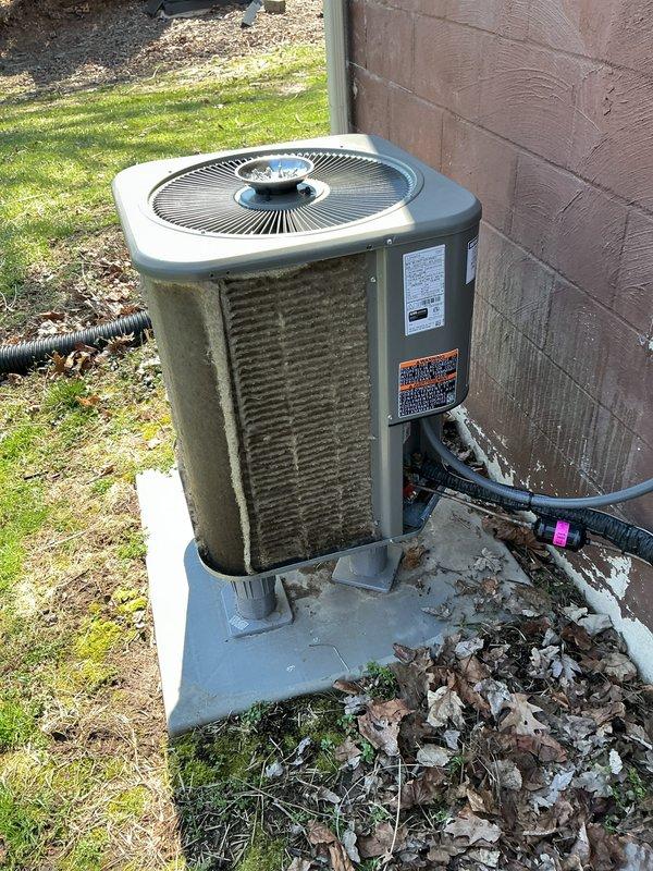 Completed annual maintenance on residential AC condenser unit. Upon arrival, noted heavy mold, mildew, and algae growth covering exterior cabinet panels and coil surfaces. Performed thorough coil cleaning to remove biological contamination and debris buildup from condenser fins. Cleared accumulated leaves and organic matter from base of unit and surrounding concrete pad. Inspected all accessible components, verified proper operation of condenser fan, and documented pre- and post-service conditions with photographs. Unit operating within normal parameters following cleaning and maintenance procedures.