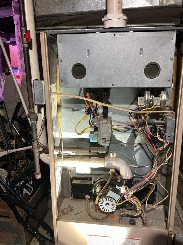 Responded to no-heat call on residential furnace system over 15 years old. Customer reported unit cycling through ignition sequence with igniter glowing red hot, followed by brief gas ignition and blower operation before shutting down and repeating the cycle. Upon arrival, performed visual inspection of internal components with access panel removed. Observed gas valve assembly, pressure switches, and burner compartment. Conducted combustion analysis testing and measured carbon monoxide levels at exhaust, which registered 232 ppm, indicating incomplete combustion and confirming unsafe operating conditions. The short-cycling behavior combined with elevated CO readings pointed to heat exchanger failure, a common issue in furnaces of this age. Documented equipment condition with photos of internal components and combustion test results. Advised customer of findings and safety concerns regarding cracked or compromised heat exchanger preventing safe operation.