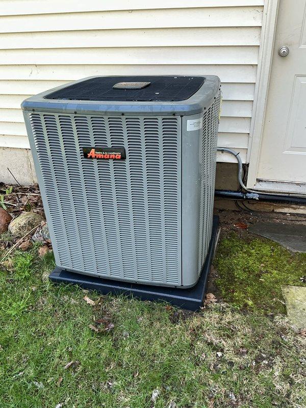 Completed annual cooling maintenance on Amana outdoor condensing unit. Performed comprehensive system inspection including visual assessment of cabinet condition, refrigerant lines, electrical connections, and conduit. Unit found operating within normal parameters with no visible signs of damage, excessive wear, or refrigerant leaks. Cleared minor debris and leaves from base area surrounding equipment. Verified proper unit placement on pad and confirmed adequate clearances for airflow around all sides of condenser. All manufacturer labels and identification tags present and legible for future service reference.