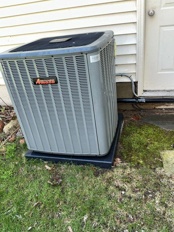 Completed annual cooling maintenance on Amana outdoor condensing unit. Performed comprehensive system inspection including visual assessment of cabinet condition, refrigerant lines, electrical connections, and conduit. Unit found operating within normal parameters with no visible signs of damage, excessive wear, or refrigerant leaks. Cleared minor debris and leaves from base area surrounding equipment. Verified proper unit placement on pad and confirmed adequate clearances for airflow around all sides of condenser. All manufacturer labels and identification tags present and legible for future service reference.