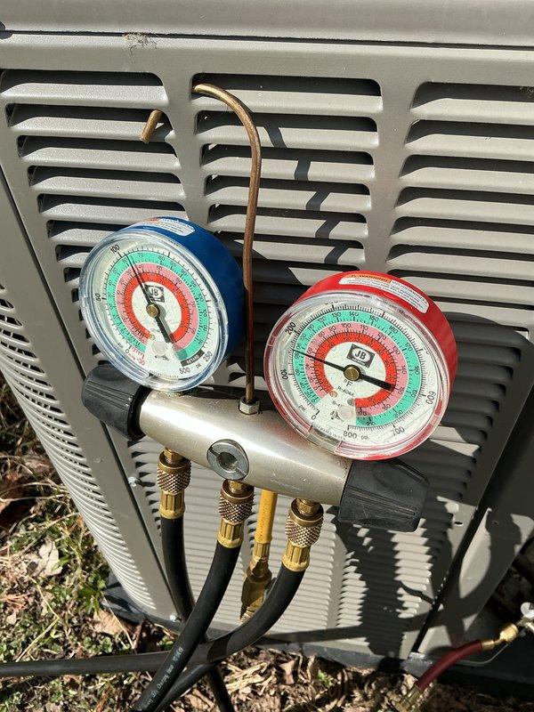 Performed annual air conditioning maintenance on residential split system. Connected refrigerant manifold gauges to service ports and verified system pressures and temperatures were within manufacturer specifications. Inspected refrigerant lines, connections, and outdoor condensing unit for proper operation and potential issues. All components functioning normally with no refrigerant leaks detected and system operating at optimal efficiency.