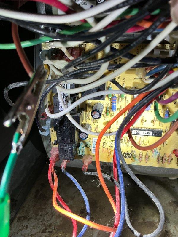 Responded to no-heat call on forced air furnace system affected by basement flooding. Performed thorough inspection of furnace components with focus on Emerson control board and electrical connections that were exposed to water. Documented water damage to control board assembly, wiring harnesses, and terminal connections through detailed photography. Advised that system requires complete cleaning and drying of all affected components before attempting restart to prevent electrical shorts or component failure. Recommended professional cleaning of control board, inspection of all wire connections for corrosion, and verification of proper system operation once dried to ensure safe restoration of heating capability.