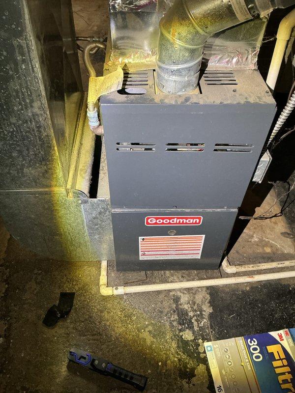 Completed routine Air Care Cooling maintenance on Goodman furnace system in basement mechanical room. Performed standard ACM inspection protocol including visual assessment of unit condition, ductwork connections, and surrounding utility space. All system components photographed and documented, with flexible ductwork and mechanical connections verified for proper installation and secure attachment to primary HVAC equipment.