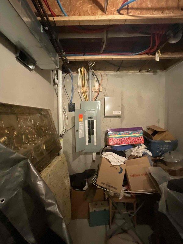 Responded to service call for furnace not maintaining set temperature. Inspected 17+ year old Carrier HVAC system located in basement consisting of stacked air handler and furnace unit. Performed diagnostic evaluation of heating system operation, thermostat communication, and temperature control functionality. Documented equipment condition with photos showing complete system installation including ductwork, electrical connections, and surrounding utility area. Previous service visit conducted nine months prior with service credit applied to current diagnostic assessment.