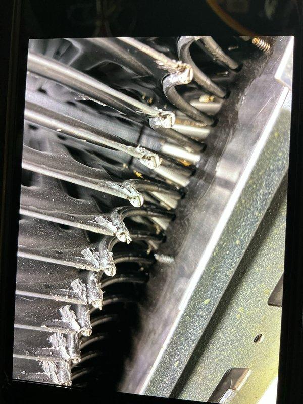 Responded to no heat call on 21-year-old furnace located in basement displaying error codes 13 and 33. Upon inspection, found significant corrosion and oxidation on evaporator coil assembly connection points and refrigerant tubes. Documented extensive wear patterns on heat exchanger components, with visible rust discoloration at tube connections and accumulated dust and debris between aluminum fins. Advised customer of equipment age and deteriorated condition of critical components requiring attention.