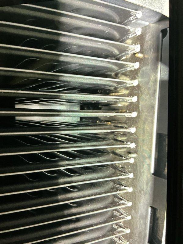 Responded to no heat call on 21-year-old furnace located in basement displaying error codes 13 and 33. Upon inspection, found significant corrosion and oxidation on evaporator coil assembly connection points and refrigerant tubes. Documented extensive wear patterns on heat exchanger components, with visible rust discoloration at tube connections and accumulated dust and debris between aluminum fins. Advised customer of equipment age and deteriorated condition of critical components requiring attention.