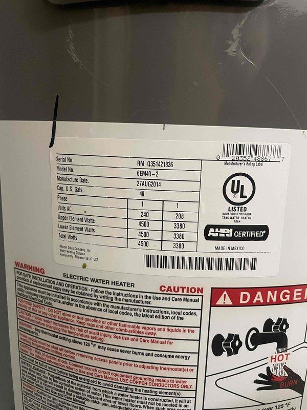 Completed on-site assessment of existing 40-gallon electric water heater (Model GEN40-2, manufactured August 2014) to provide replacement estimate and rent-to-own program information. Documented current unit specifications including 240V/4500W configuration, recorded dimensional measurements of installation space in attic location, and photographed equipment labels and access panels to determine replacement requirements and compatibility with existing plumbing and electrical connections.