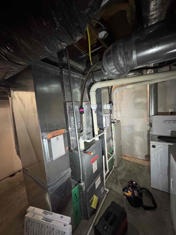Completed scheduled commercial HVAC maintenance agreement service on multi-unit system including two gas furnaces, two air conditioning units, and one hot water tank. Performed comprehensive inspection of all equipment in basement mechanical room, checking operational status of furnace burners, heat exchangers, blowers, and electrical components. Inspected ductwork connections and flexible ducting for proper sealing and airflow. Verified thermostat calibration, tested safety controls, and confirmed proper venting. Examined air conditioning units for refrigerant levels, compressor operation, and condensate drainage. Inspected hot water tank for proper function and safety valve operation. All equipment found operating within manufacturer specifications with no immediate repairs required.