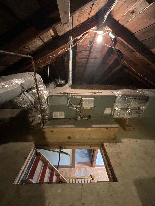 Conducted comprehensive assessment of residential attic space for first-time central air conditioning and new furnace installation in single-family home. Evaluated existing attic infrastructure, including wooden rafter system, floor joists, and available space for equipment placement. Documented current HVAC equipment configuration, including existing air handler unit with flexible aluminum ductwork distribution system and secondary furnace/air handler unit with mixed rigid and flexible duct connections. Assessed electrical service availability, condensate drainage requirements, and structural support adequacy for new equipment installation. Photographed attic access points, existing ductwork routing, mechanical equipment positioning, and available installation space. Identified need for full system replacement to add cooling capacity where none currently exists and upgrade heating equipment. Provided homeowner with detailed estimate for complete HVAC system installation including new 