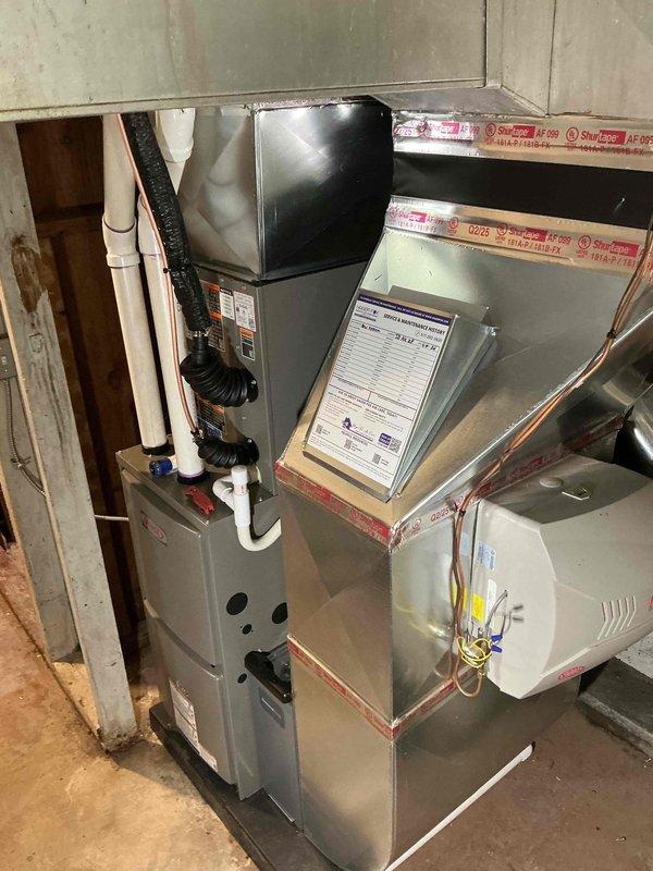 Completed full HVAC system installation including a 70,000 BTU furnace and 2-ton air conditioning unit with rear discharge configuration. Installed all necessary ductwork connections, refrigerant lines, and condensate drainage system with exterior PVC discharge piping. Reconnected all electrical components, mounted air handler, and ensured proper integration of all mechanical systems in basement utility area.