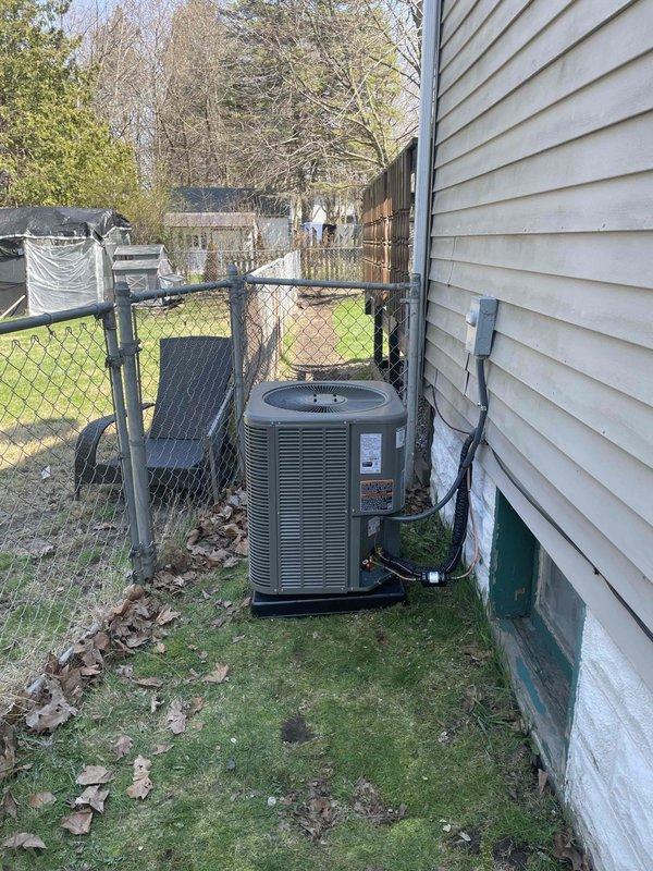 Completed full installation of 2-ton air conditioning system with evaporator coil in residential basement. Installed new outdoor condensing unit on left side of property with proper pad placement and positioning between house and fence line. Installed matching evaporator coil integrated with existing furnace system, including all necessary refrigerant line sets, condensate drainage, and electrical connections. Ran new dedicated electrical circuit to power outdoor unit per code requirements. Obtained and complied with mechanical and electrical permits for installation. System tested, charged, and verified operational upon completion.