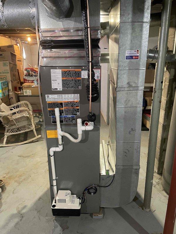 Completed full installation of 2-ton air conditioning system with evaporator coil in residential basement. Installed new outdoor condensing unit on left side of property with proper pad placement and positioning between house and fence line. Installed matching evaporator coil integrated with existing furnace system, including all necessary refrigerant line sets, condensate drainage, and electrical connections. Ran new dedicated electrical circuit to power outdoor unit per code requirements. Obtained and complied with mechanical and electrical permits for installation. System tested, charged, and verified operational upon completion.