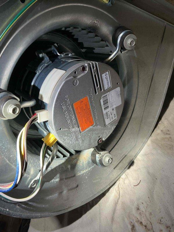 Responded to no heat call on 2+ year old furnace in basement following recent flooding event. Upon inspection, found blower motor assembly had sustained water damage and failed, preventing air circulation through the system. Removed and replaced defective blower motor with new unit, reconnected all electrical connections, and verified proper operation of furnace and air handler. System tested and confirmed heating properly with adequate airflow throughout.