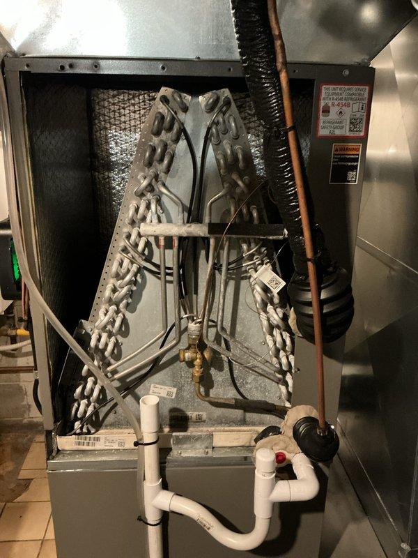 Completed comprehensive Air Care Heating and Cooling recurring maintenance service on residential HVAC system. Performed thorough inspection of evaporator coil assembly, verified refrigerant line connections and insulation integrity, checked condensate drainage system operation including trap configuration and PVC piping, and inspected furnace/air handler unit for proper function. All system components photographed and documented, equipment found operating within normal parameters.