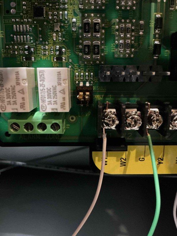 Responded to callback for furnace blower running continuously despite thermostat set to auto mode. Upon arrival, inspected the Sensi programmable thermostat and verified settings showed "Auto On" mode with system reading 68°F. Examined furnace control board and identified wiring configuration at the terminal block, including W2 and G terminals with proper wire connections (tan, white, and green wires). Verified control board relay operation and confirmed proper enable/disable settings on the PCB. Addressed customer inquiry regarding Ecobee thermostat compatibility with existing HVAC system and provided technical assessment of integration requirements. System tested and verified proper blower cycling in auto mode after service completion.