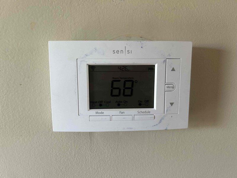 Responded to callback for furnace blower running continuously despite thermostat set to auto mode. Upon arrival, inspected the Sensi programmable thermostat and verified settings showed "Auto On" mode with system reading 68°F. Examined furnace control board and identified wiring configuration at the terminal block, including W2 and G terminals with proper wire connections (tan, white, and green wires). Verified control board relay operation and confirmed proper enable/disable settings on the PCB. Addressed customer inquiry regarding Ecobee thermostat compatibility with existing HVAC system and provided technical assessment of integration requirements. System tested and verified proper blower cycling in auto mode after service completion.
