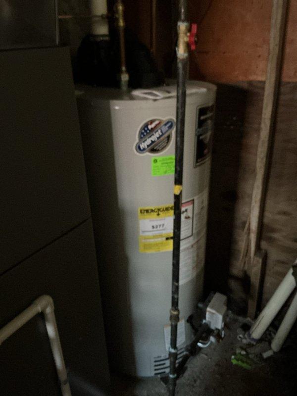 Performed comprehensive ComfortGuard maintenance package on residential HVAC system. Addressed specialty service request for high-efficiency filter replacement and evaporator pad servicing. Inspected outdoor heat pump unit and identified significant organic debris accumulation in base pan around compressor and coil assembly, including decomposed leaf matter and moisture retention indicating potential drainage concerns. Removed accumulated debris, cleaned unit interior, and verified proper condensate drainage. Examined refrigerant lines showing minor surface oxidation consistent with normal weathering. Replaced air filtration media and evaporator humidifier pad as requested. Conducted visual inspection of water heater and associated mechanical systems in utility area. All components operational upon completion of maintenance service.