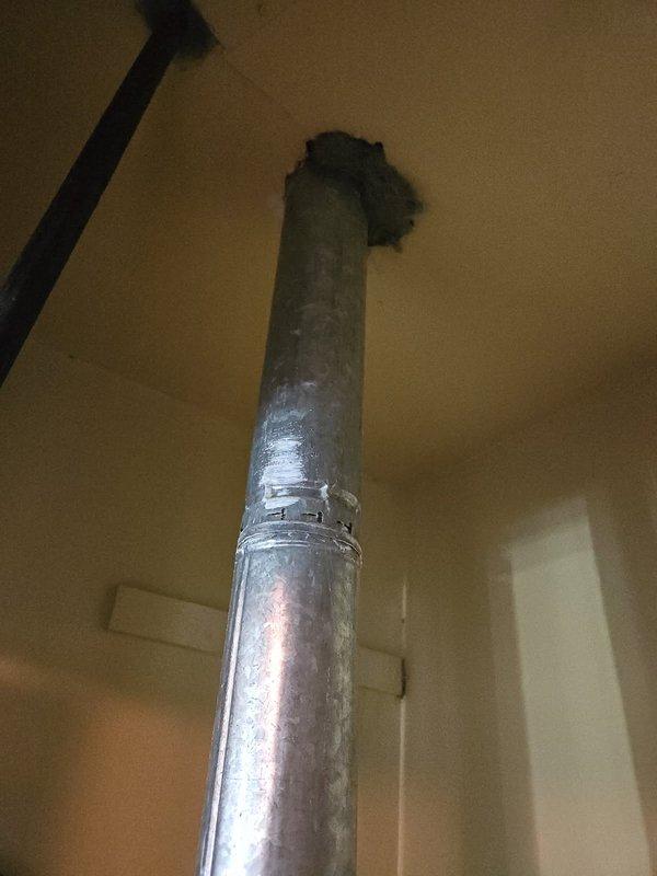 Completed ACM service call on water heater system at unit 4/910-2. Inspected water heater installation, verified proper venting configuration with metallic B-vent pipe extending through ceiling, and confirmed secure pipe connections and supports. Documented existing conditions including copper piping loop, gas line with shutoff valve, and ceiling penetration seal. All components photographed for service records per customer request.