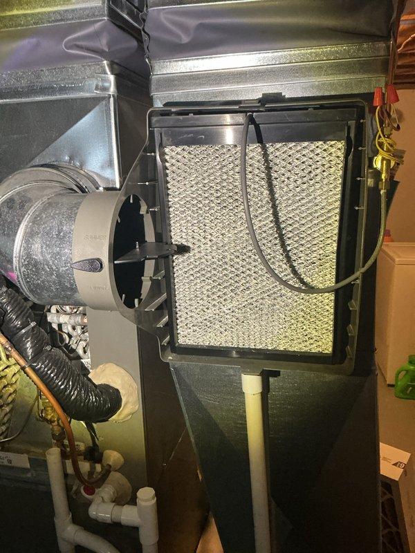 Completed routine Air Care Cooling maintenance on residential HVAC system. Performed comprehensive inspection of evaporator coil unit in attic space, verifying proper operation of serpentine copper tubing arrangement and checking condition of coil insulation. Inspected yellow condensate drain pan and white PVC drainage system for proper flow and potential blockages. Examined air handler unit with mesh filter, confirming adequate airflow and filter condition. Verified integrity of refrigerant lines, electrical connections, and flex ductwork connections throughout the system. All components found operating within normal parameters with no immediate service needs identified.