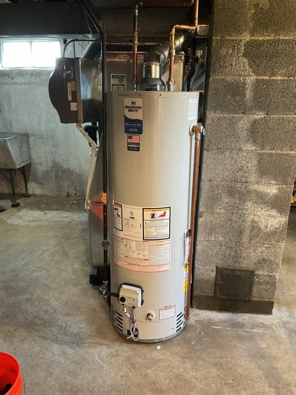Responded to no hot water condition following basement flooding incident. Upon inspection, determined existing water heater had been compromised by water damage. Removed failed unit and installed new 40-gallon Bradford White automatic storage gas water heater with proper venting and plumbing connections, restoring full domestic hot water service to the residence.