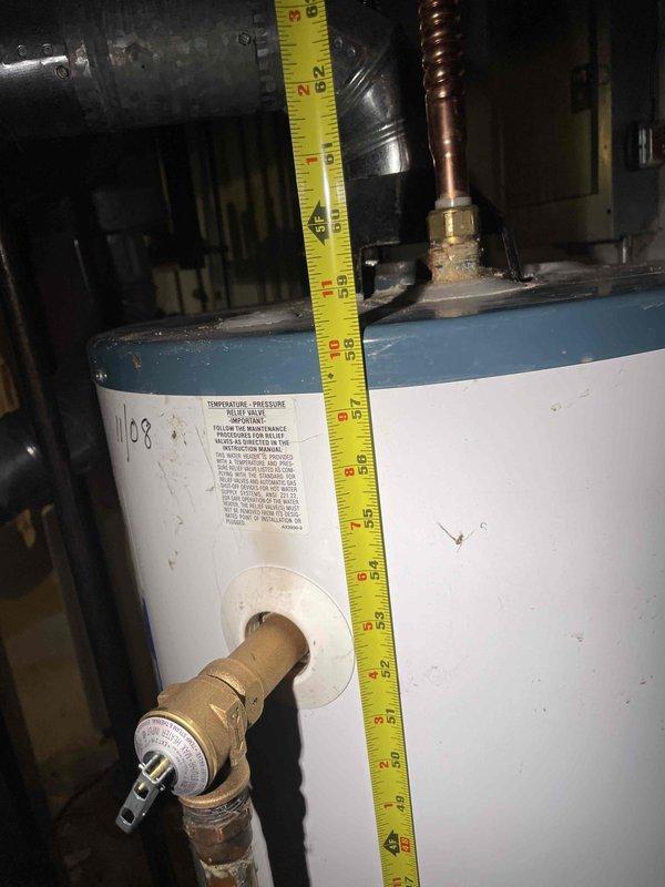 Conducted water heater assessment at multi-family condominium complex for non-functional unit serving units 168-174. Documented existing equipment specifications and measurements, noting approximately 8-foot installation height with standard brass fittings and pressure relief valve configuration. Identified need to confirm venting type (power vent versus natural draft) and verify main billing address before proceeding with replacement recommendation.
