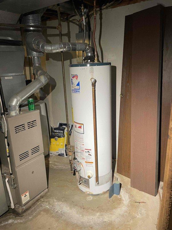 Conducted water heater assessment at multi-family condominium complex for non-functional unit serving units 168-174. Documented existing equipment specifications and measurements, noting approximately 8-foot installation height with standard brass fittings and pressure relief valve configuration. Identified need to confirm venting type (power vent versus natural draft) and verify main billing address before proceeding with replacement recommendation.