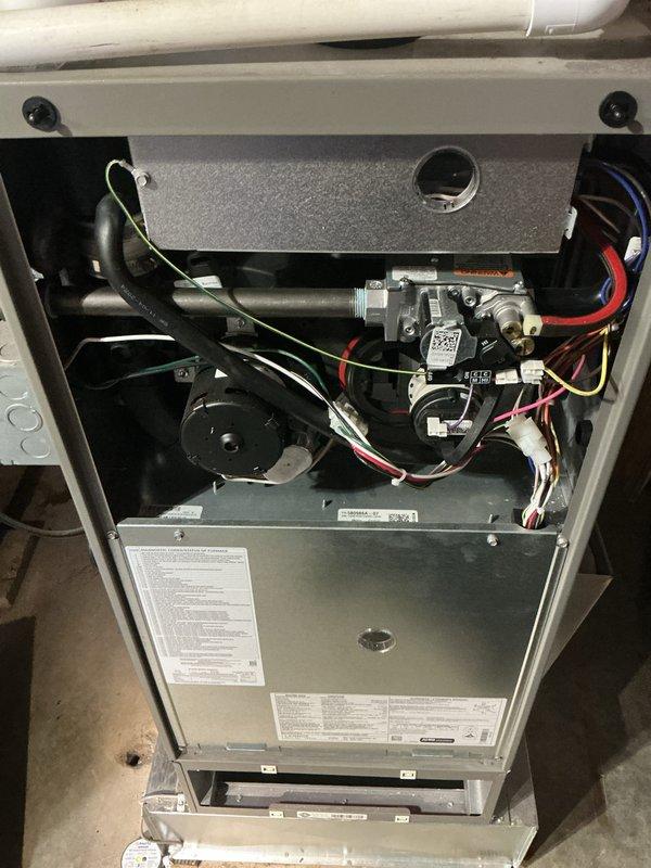 Completed comprehensive HVAC maintenance inspection on air handler and furnace unit. Inspected air filter showing normal dust accumulation on pleated media, verified proper installation within housing. Examined internal furnace components including gas valve assembly with electronic controls, blower motor assembly, and all associated wiring connections. Verified proper operation of safety controls, condensate drain lines, and electrical connections. All components found operating within normal parameters with no issues requiring immediate attention.