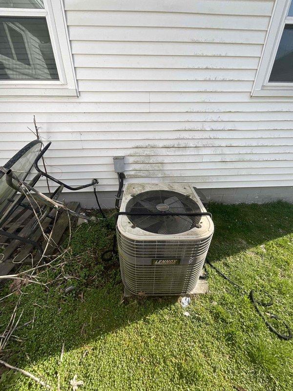 Conducted on-site evaluation for furnace replacement estimate on a 30-year-old heating system originally installed in 1996. Performed visual inspection of existing Lennox outdoor condensing unit positioned on concrete pad adjacent to home's foundation, noting refrigerant lines and electrical conduit routing up exterior wall. Assessed electrical service capacity by examining main breaker panel and circuit distribution in basement utility area to ensure adequate power supply for proposed equipment upgrade. Documented current HVAC infrastructure including ductwork accessibility and existing equipment configuration to provide accurate replacement recommendations and specifications for new high-efficiency furnace installation.