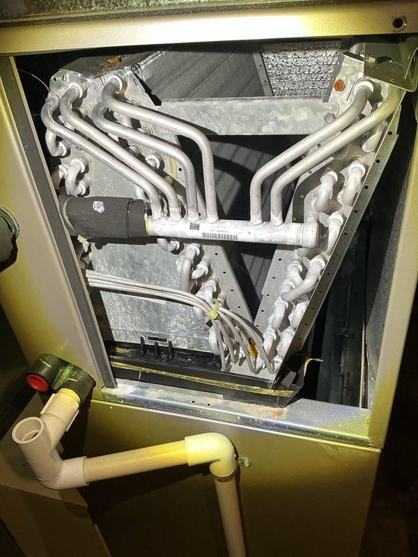 Completed annual comprehensive maintenance on HVAC air handler unit per service agreement. Performed thorough inspection of evaporator coil assembly, verified proper refrigerant line connections, and checked condensate drain system for proper operation. Documented equipment condition with photos showing A-frame coil configuration and overall unit status, confirming all components are functioning within normal parameters.