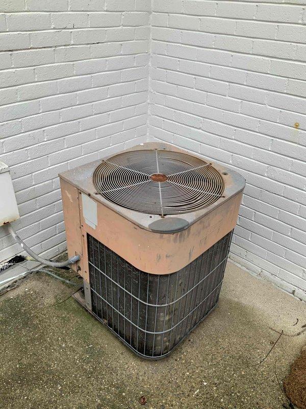 Completed estimate for replacement of 20+ year old natural gas furnace and air conditioning system under promotional offer. Existing equipment located in basement with outdoor condenser unit positioned on concrete pad between white brick walls. Both units currently operational but at end of service life, requiring full system replacement evaluation.