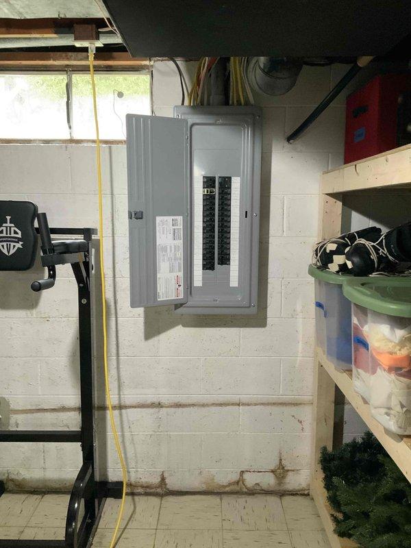 Completed estimate for replacement of 20+ year old natural gas furnace and air conditioning system under promotional offer. Existing equipment located in basement with outdoor condenser unit positioned on concrete pad between white brick walls. Both units currently operational but at end of service life, requiring full system replacement evaluation.