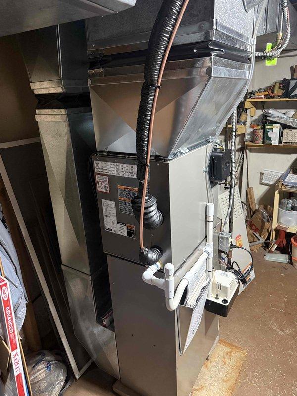 Completed installation of 2-ton air conditioning system with evaporator coil in basement utility room, configured for left-side placement. Installed new AC unit with proper refrigerant line connections, mounted evaporator coil to existing furnace plenum, and established electrical reconnection per code requirements. System commissioned and tested for proper airflow, refrigerant charge, and operational performance. All mechanical and electrical permits obtained prior to installation, with work completed in accordance with local building codes and manufacturer specifications.