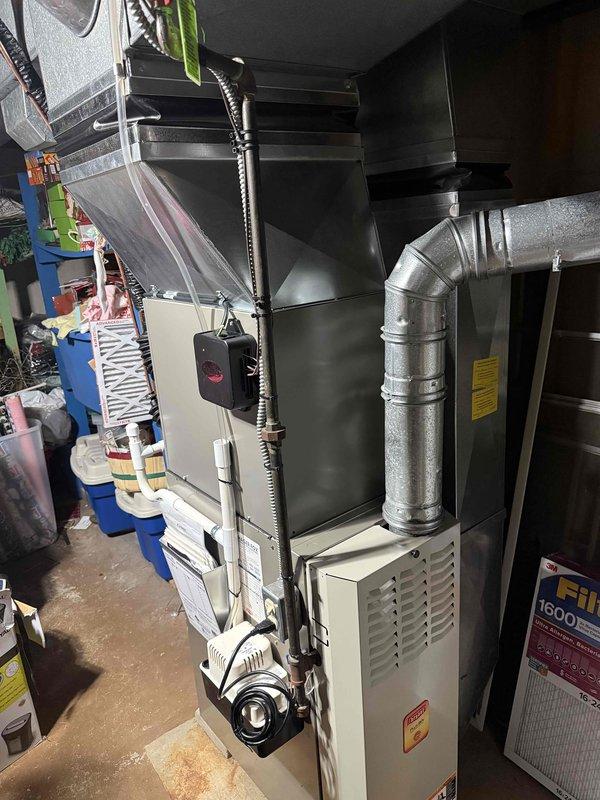 Completed installation of 2-ton air conditioning system with evaporator coil in basement utility room, configured for left-side placement. Installed new AC unit with proper refrigerant line connections, mounted evaporator coil to existing furnace plenum, and established electrical reconnection per code requirements. System commissioned and tested for proper airflow, refrigerant charge, and operational performance. All mechanical and electrical permits obtained prior to installation, with work completed in accordance with local building codes and manufacturer specifications.