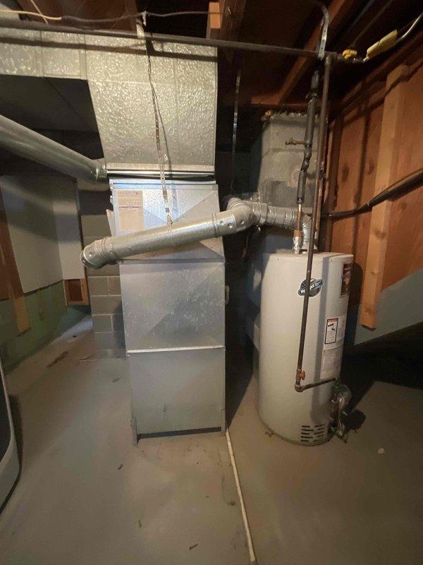 Responded to service call for non-operational water heater and HVAC system in basement utility area following flooding incident that extinguished pilot light. Conducted comprehensive assessment of furnace, air conditioning system, and water heater to evaluate equipment condition and determine repair versus replacement recommendations. Provided full system estimate covering furnace replacement, water heater installation, and air conditioning unit upgrade options, including equipment raising considerations to prevent future flood damage to mechanical systems.